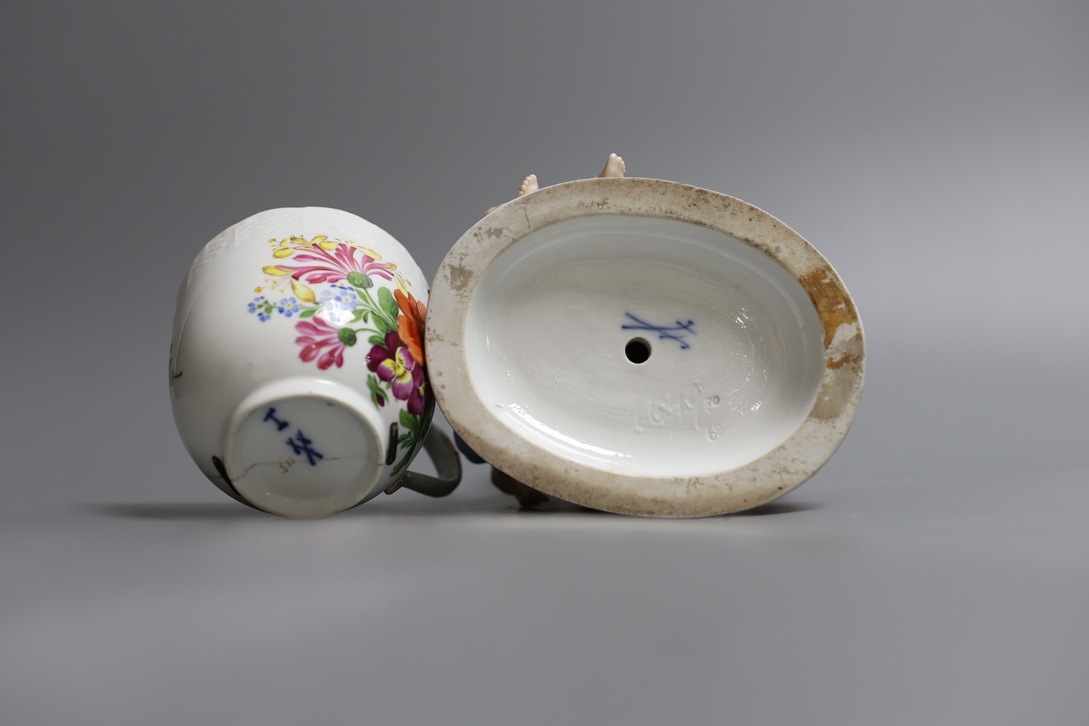 A Meissen cherub centrepiece, a similar cup and box base, together with two Meissen style jars and covers, centrepiece 16 cms high
